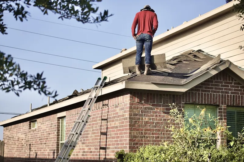 Professional roofer working on a residential roof in East Bridgewater